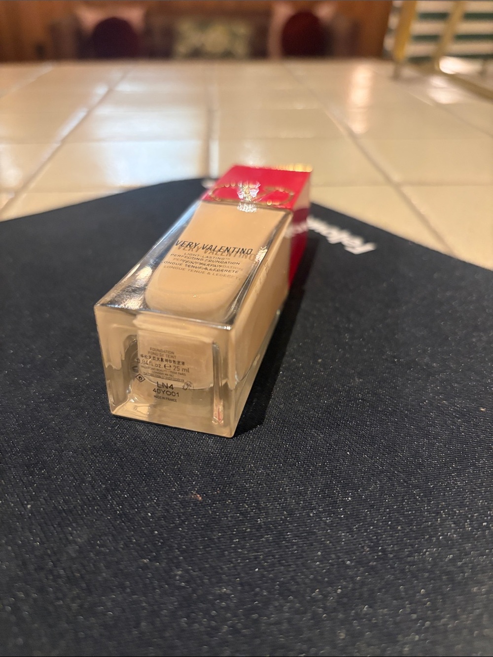 Valentino foundation bottle with red cap and beige serum LN4